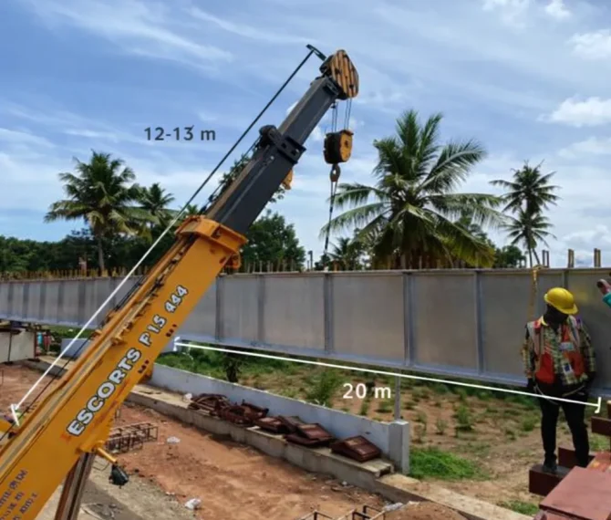 Mobile crane lifting metal girder